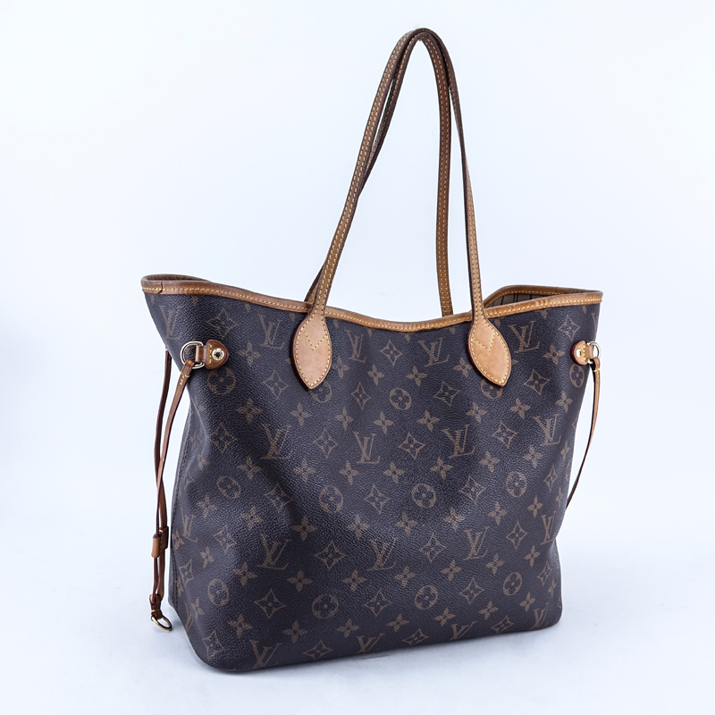 Louis Vuitton Brown Monogram Coated Canvas And Leather Neverfull MM Handbag. Golden brass hardware, signature canvas interior with zippered pocket, vachetta straps.
