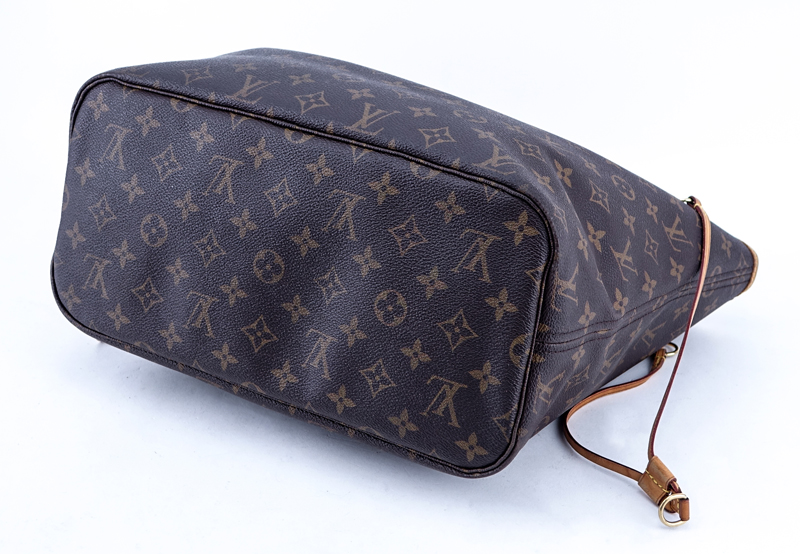 Louis Vuitton Brown Monogram Coated Canvas And Leather Neverfull MM Handbag. Golden brass hardware, signature canvas interior with zippered pocket, vachetta straps.