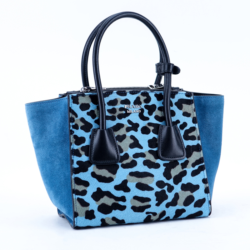 Prada Sky Blue/Black Leopard Print Pony And Suede Heaven Bag PM. Silver tone hardware, the interior of black signature fabric with zippered and patch pockets, black leather handles.