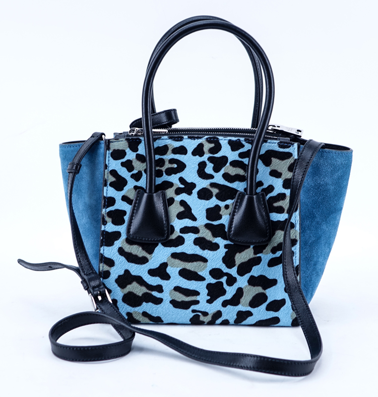 Prada Sky Blue/Black Leopard Print Pony And Suede Heaven Bag PM. Silver tone hardware, the interior of black signature fabric with zippered and patch pockets, black leather handles.