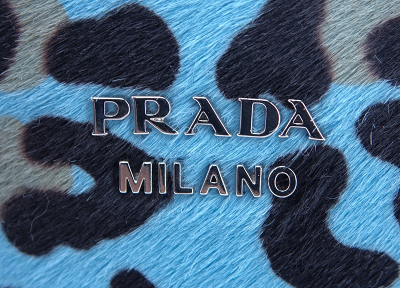 Prada Sky Blue/Black Leopard Print Pony And Suede Heaven Bag PM. Silver tone hardware, the interior of black signature fabric with zippered and patch pockets, black leather handles.