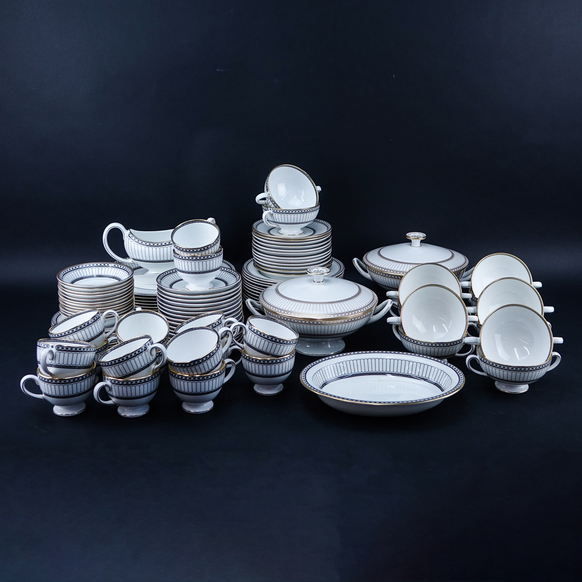 One Hundred Nine (109) Piece Wedgwood Colonnade Dinnerware. Includes in black: 12 plates 10-3/4", 12 salad plates, 12 bread & butter plates, 12 fruit bowls, 12 handled soup cups and 12 saucers, 16 ups and 16 saucers, gravy boat, 2 open serving dishes.