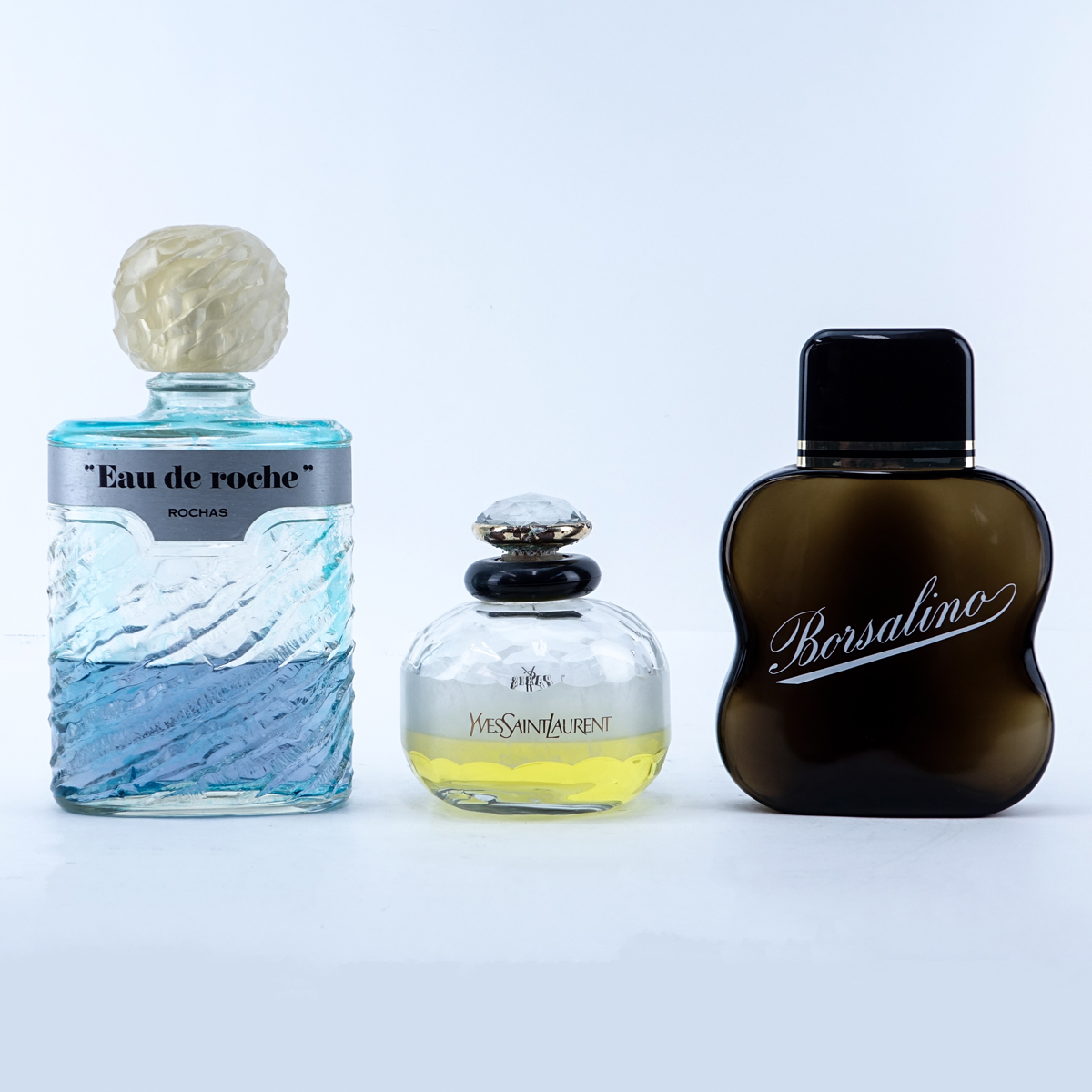 Grouping of Three (3): Yves Saint Laurent Factice, Rochas "Eau de Roche" Factice, Borsalino Factice. Used condition.