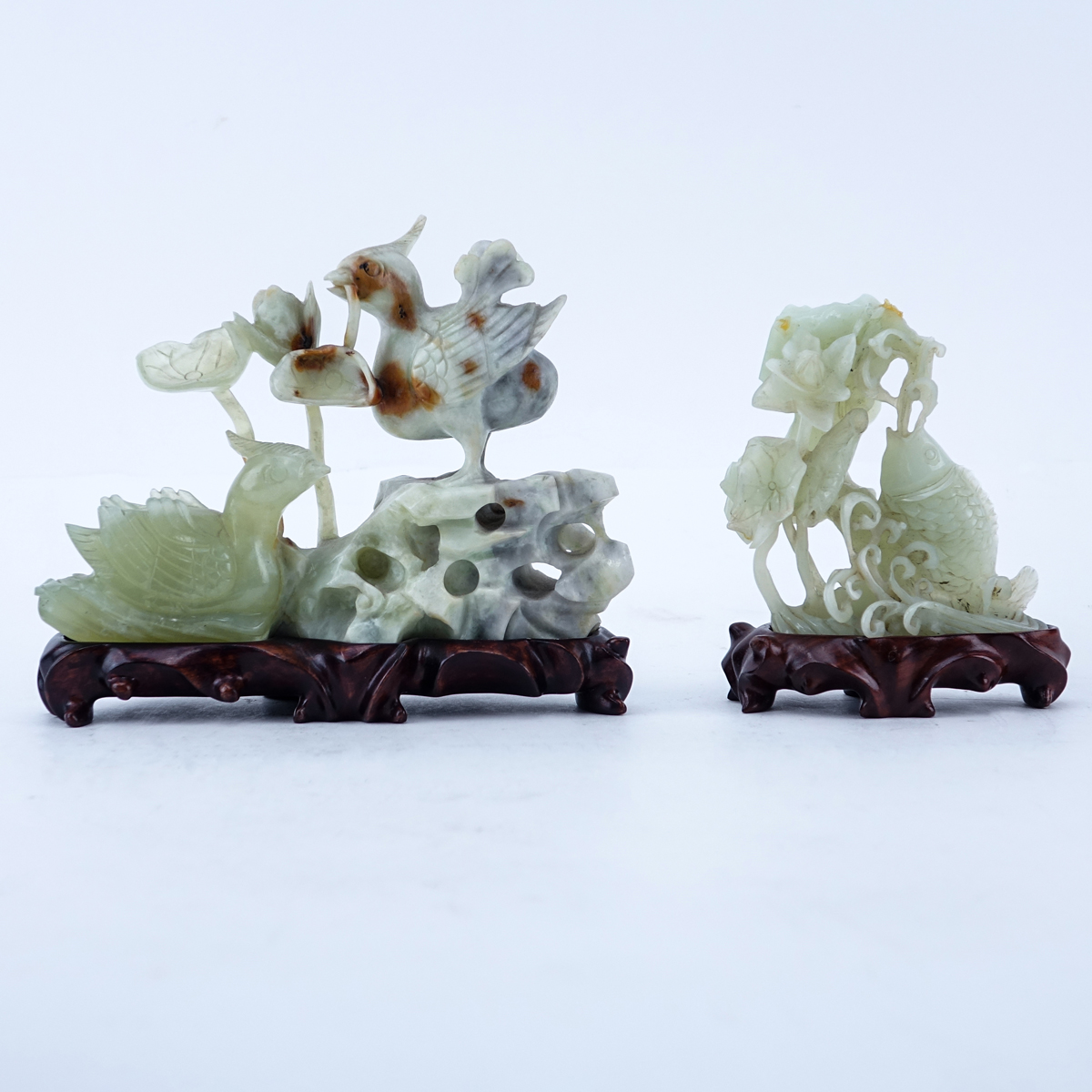 Grouping of Two (2): Chinese Carved Serpentine Jade Group, Chinese Carved Serpentine Jade Fish Group. Each on fitted wooden bases.