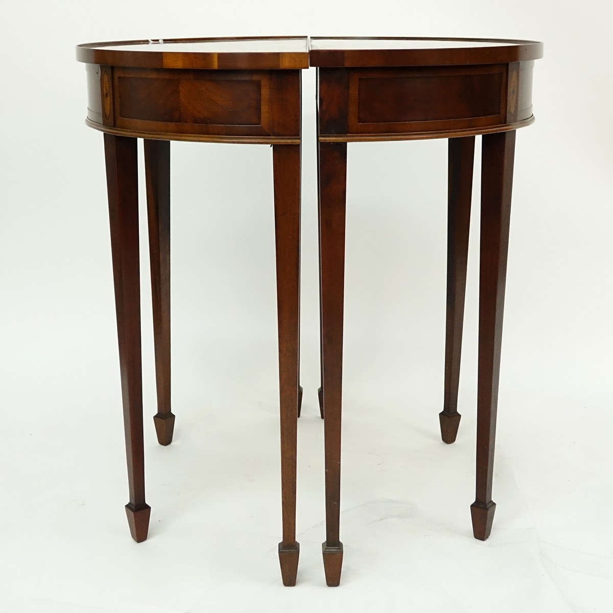 Pair of Sheraton Style Flame Mahogany, Marquetry Inlaid Demi Lune Tables. Light scuffs to top on both, one has wear to veneered top.