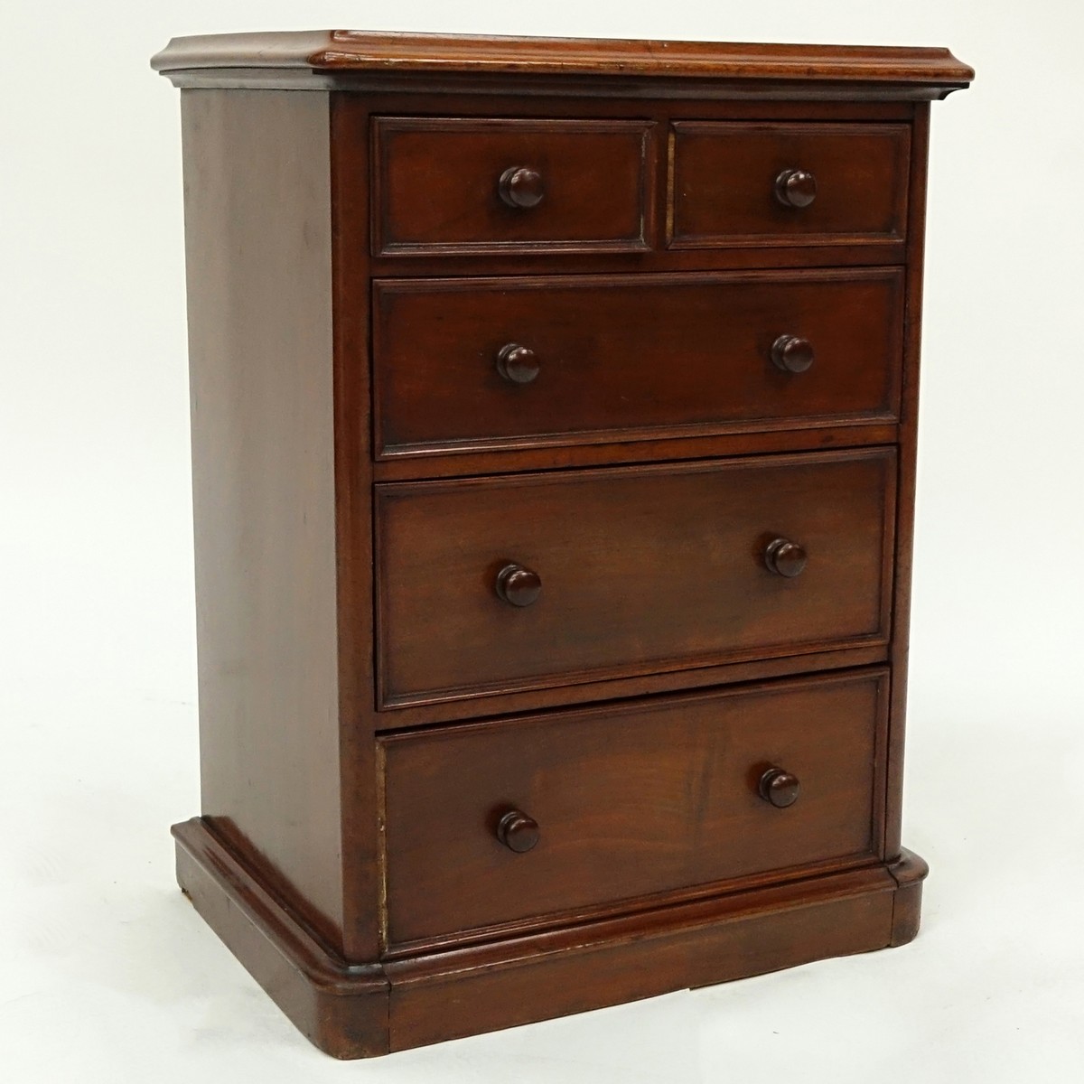 Antique English Miniature Chest of Drawers. Some losses to molding, wear to varnish, light scuffs otherwise good condition.