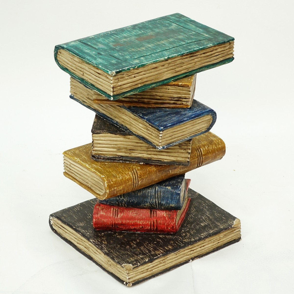 Hand Carved and Painted End Table in the form of Stacked Books. Wear to the corners at the base, rubbing to paint.