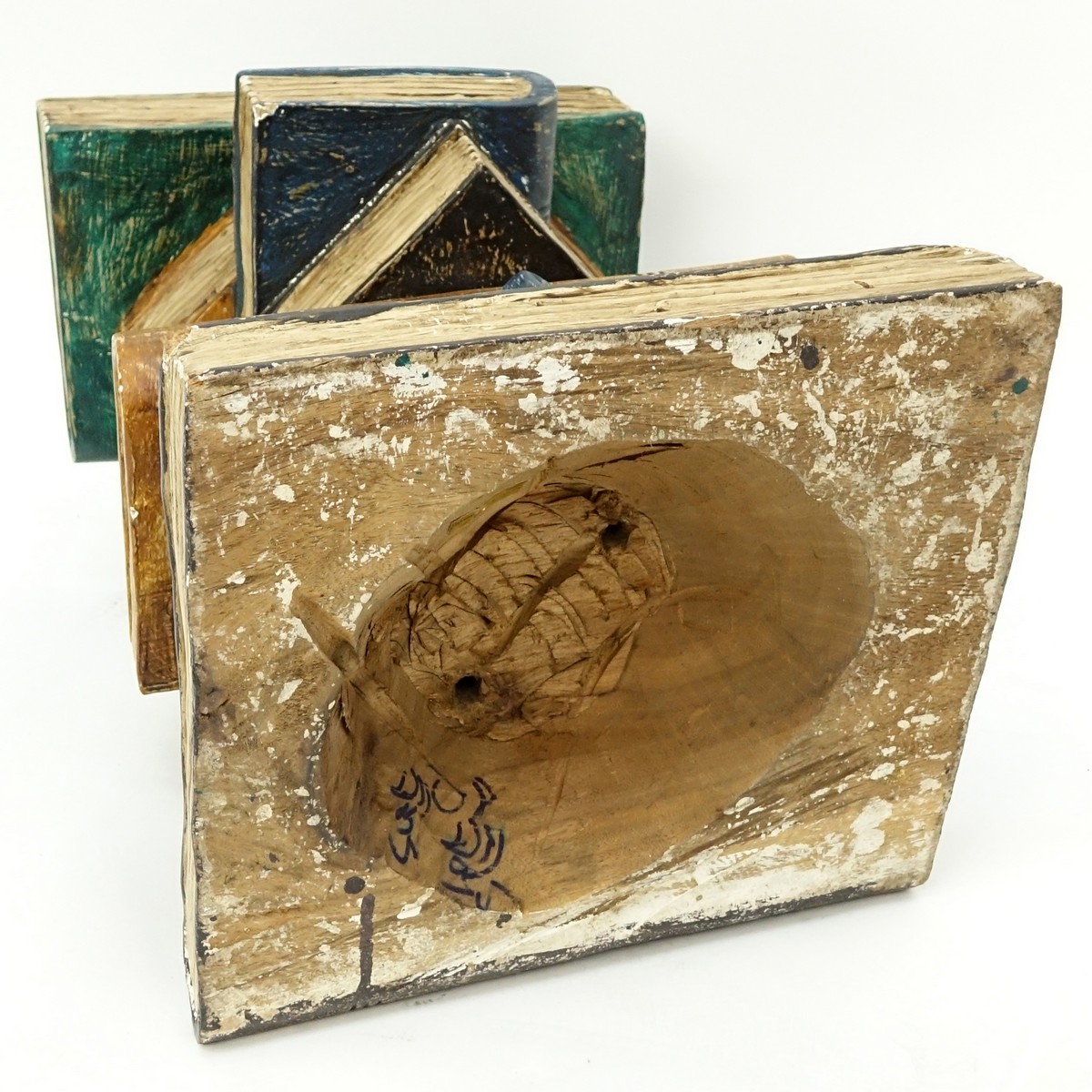 Hand Carved and Painted End Table in the form of Stacked Books. Wear to the corners at the base, rubbing to paint.