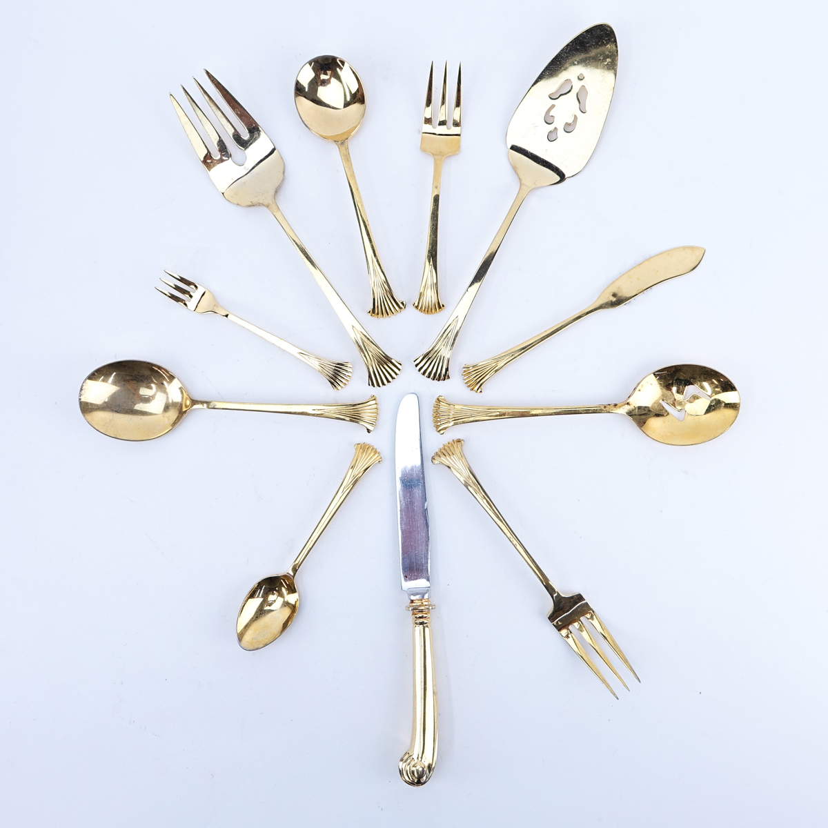 Ninety Eight (98) Pieces Oxford House Gold Plated Stainless Flatware. Set includes: 12 forks 7-1/4", 17 knives 9-1/2", 16 salad forks, 7 soup spoons, 9 teaspoons, 12 cocktail forks, 20 butter paddles, meat fork, slotted spoon, pie server, 2 serving spoons