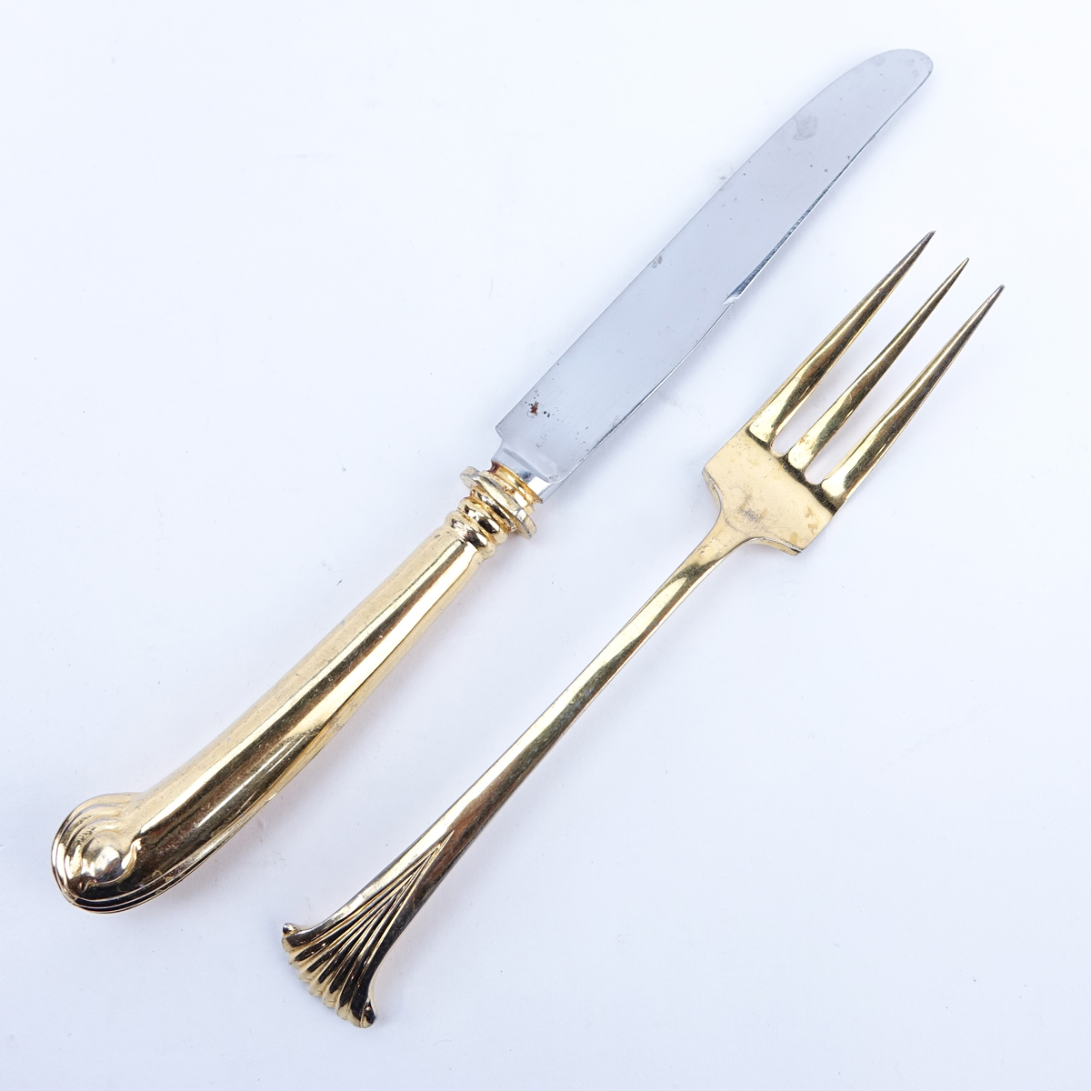 Ninety Eight (98) Pieces Oxford House Gold Plated Stainless Flatware. Set includes: 12 forks 7-1/4", 17 knives 9-1/2", 16 salad forks, 7 soup spoons, 9 teaspoons, 12 cocktail forks, 20 butter paddles, meat fork, slotted spoon, pie server, 2 serving spoons