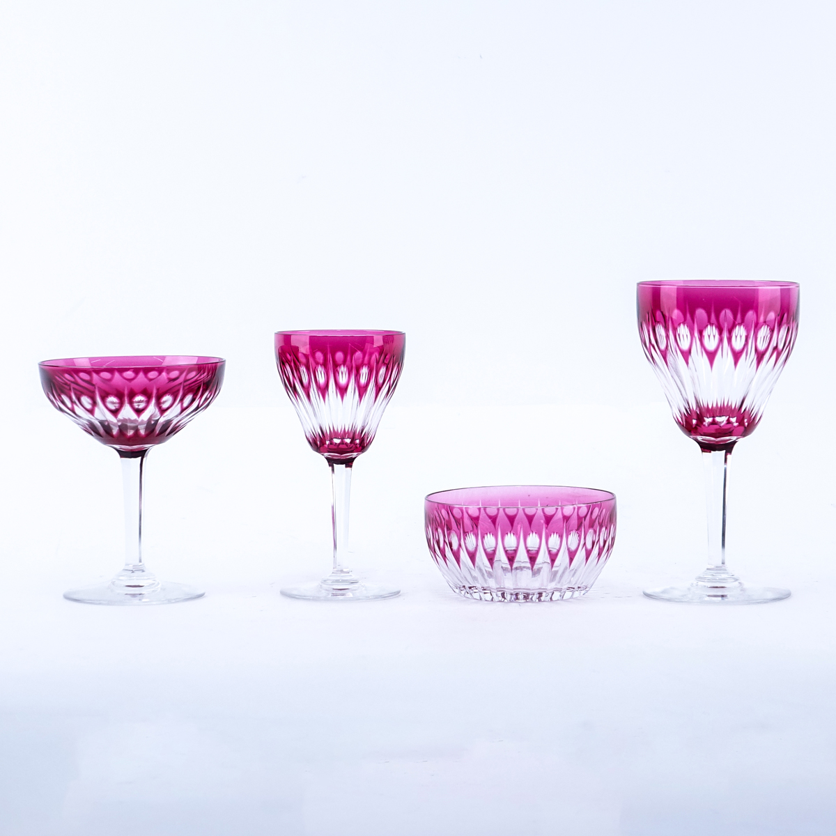 Forty Two (42) Piece Bohemian Style Cranberry to Clear Stemware. Includes: 9 red wine glasses 6-3/4" H, 12 white wines glasses 5-1/2" H, 9 champagne glasses 5" H, and 12 bowls 4" Dia.