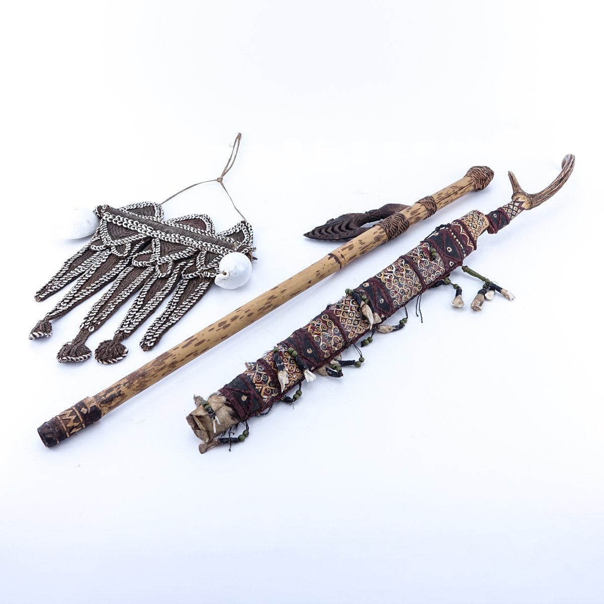 Antique Dayak Tribal Grouping of Three (3): Large Sword with Carved Antler Handle, Blowgun, and Beaded and Shell Hanging Ornament/Necklace. Condition is consistent with age, chips and nicks.