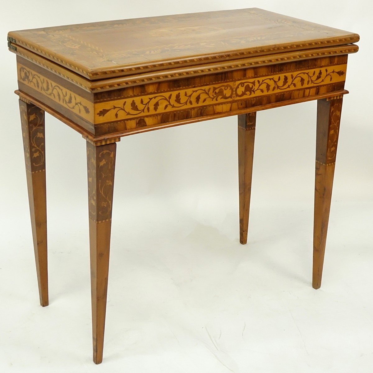 Antique Marquetry Inlaid Flip Top Game Table. Floral and scenic inlay work throughout the surface.