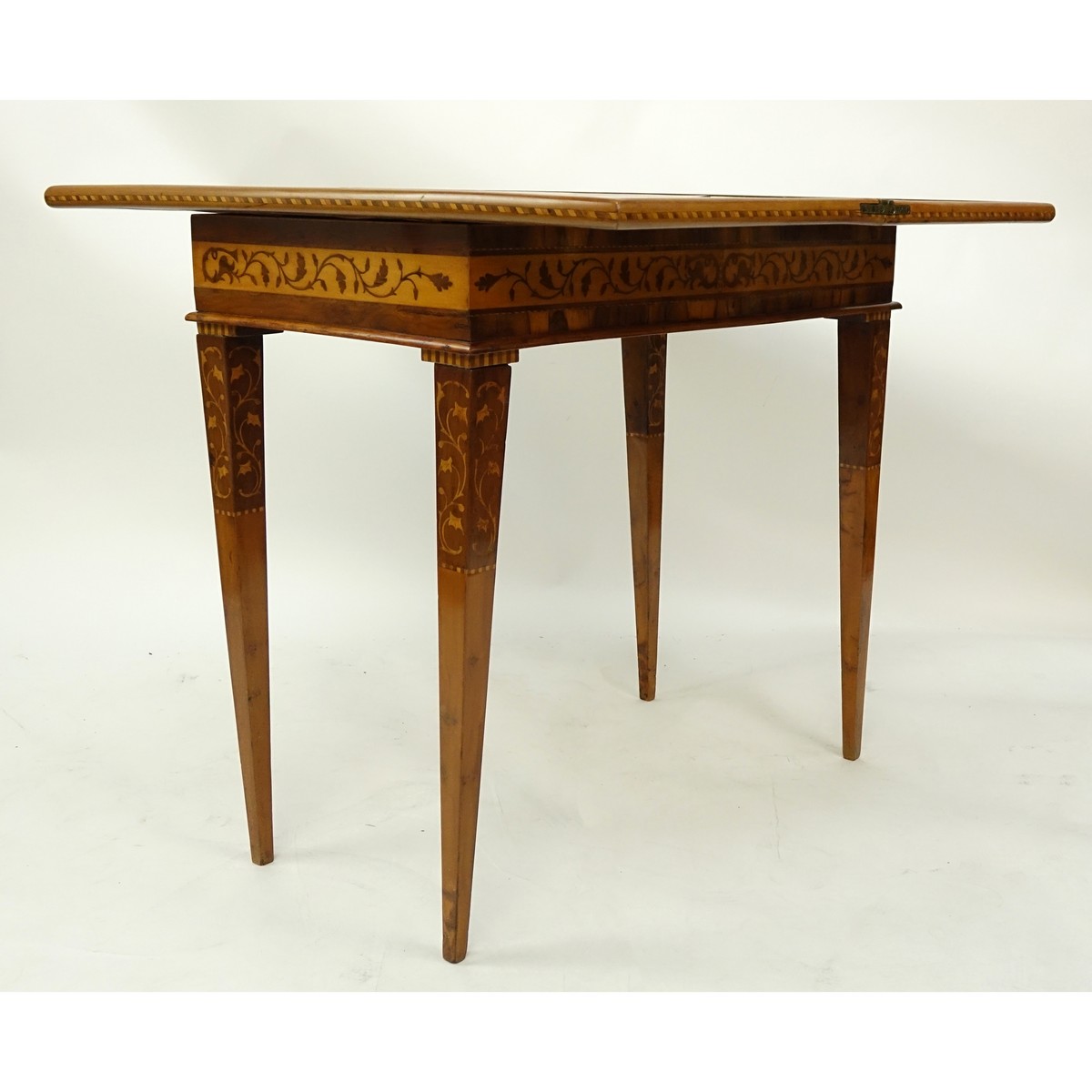 Antique Marquetry Inlaid Flip Top Game Table. Floral and scenic inlay work throughout the surface.