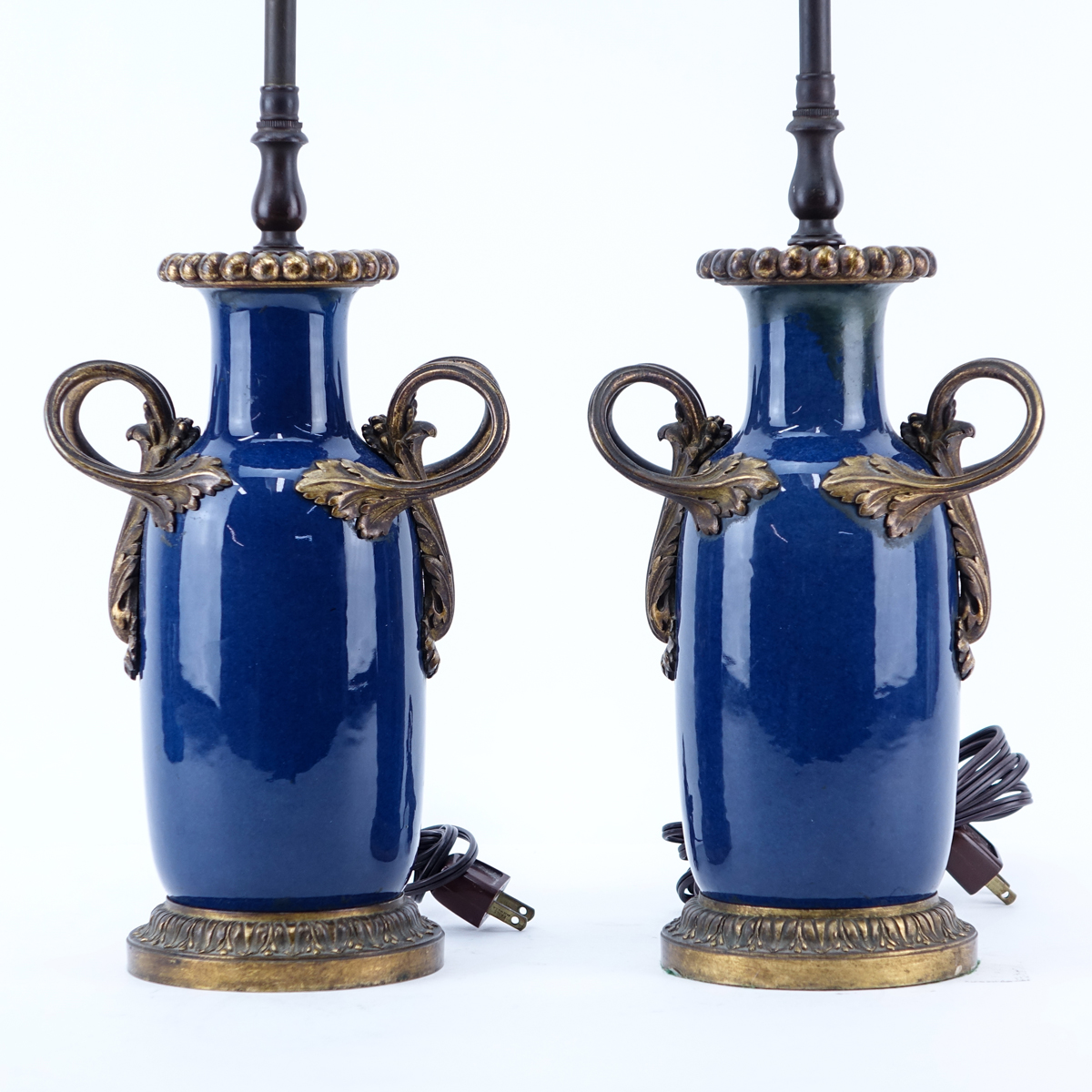 Pair of Gilt Bronze Mounted Cobalt Glazed Porcelain Lamps. Possible restoration or rubbing along the rim and handles.