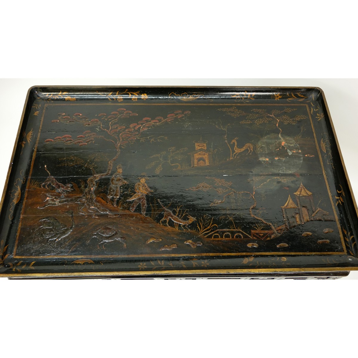 19th Century Chinese Export Lacquer Table with Open Fret Work Apron and Ball and Claw Feet. Landscape scene to top with figures.