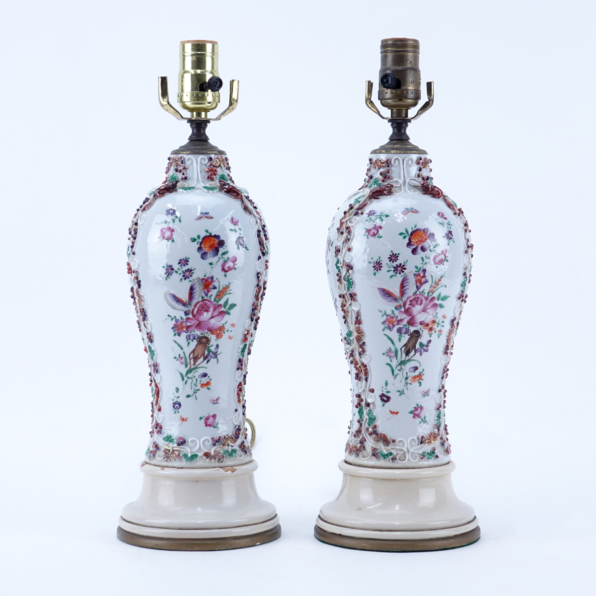 Pair of Samson Raised Floral Relief Porcelain Lamps. Typical rubbing to paint, some small nicks.