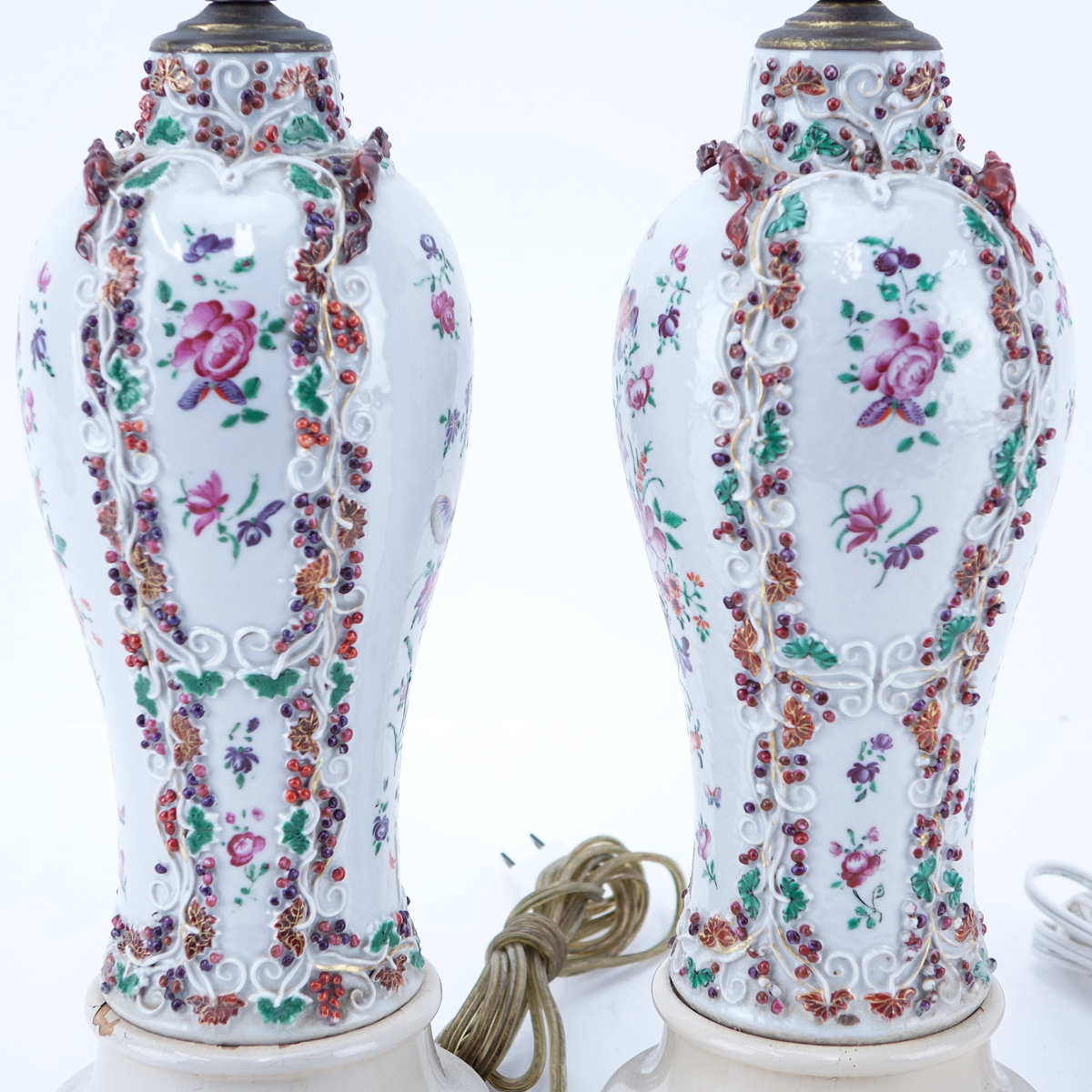 Pair of Samson Raised Floral Relief Porcelain Lamps. Typical rubbing to paint, some small nicks.