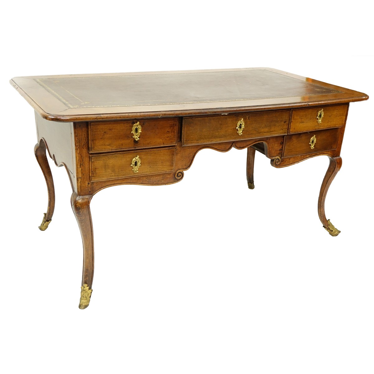 Large 19th Century French Walnut Writing Desk with Tooled Leather Top, Gilt Bronze Mounts. Large center drawer flanked by four fitted drawers, stands on tapering cabriole legs with hooves as feet.