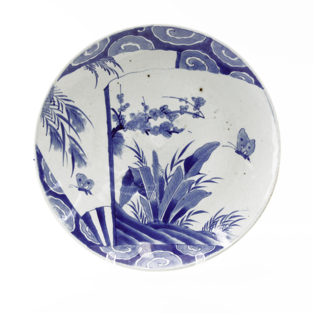 19th Century Japanese Arita Blue and White Porcelain Charger. Decorated blue glaze butterfly and flower scene, blue glazed pattern and pin pricks on underside.