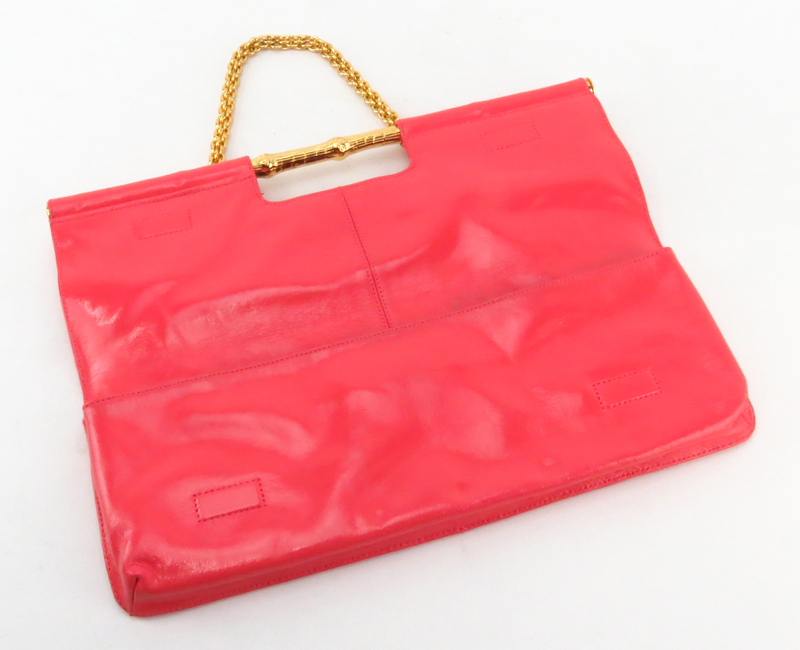 Trina Turk Salmon Pink Patent Leather Clutch. Gold-tone hardware and shoulder chain.