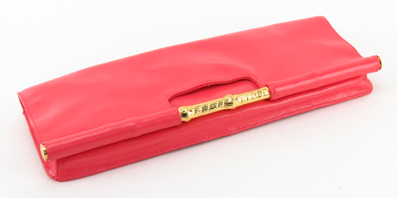 Trina Turk Salmon Pink Patent Leather Clutch. Gold-tone hardware and shoulder chain.