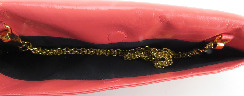Trina Turk Salmon Pink Patent Leather Clutch. Gold-tone hardware and shoulder chain.