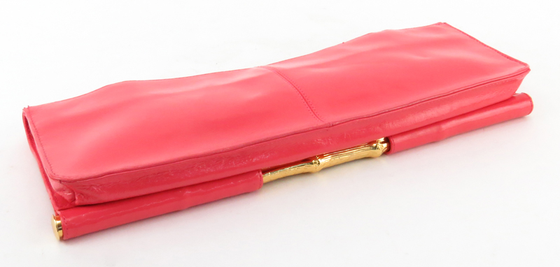 Trina Turk Salmon Pink Patent Leather Clutch. Gold-tone hardware and shoulder chain.