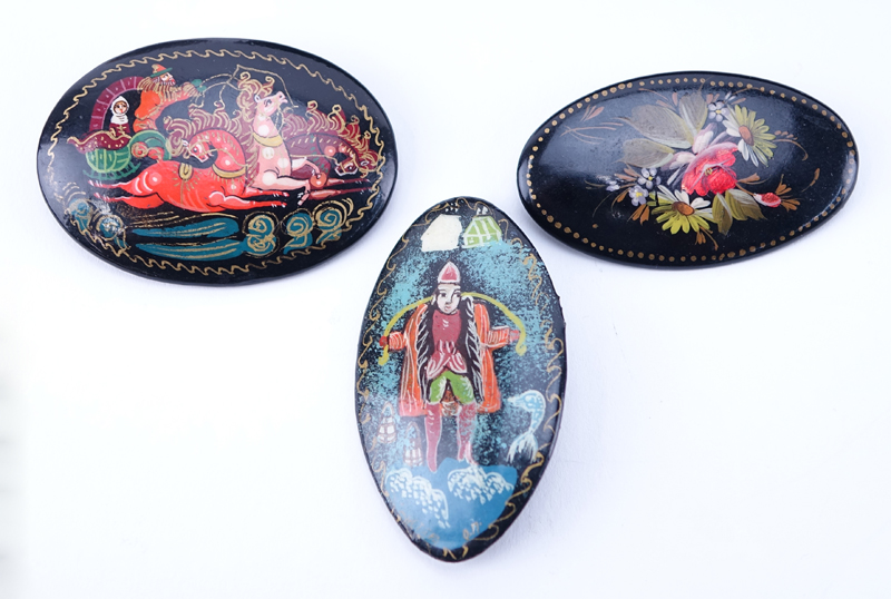 Collection of Six (6) Russian Lacquer Paper Mache Items. Includes: two hinged boxes, three pin/brooches, and egg on stand.