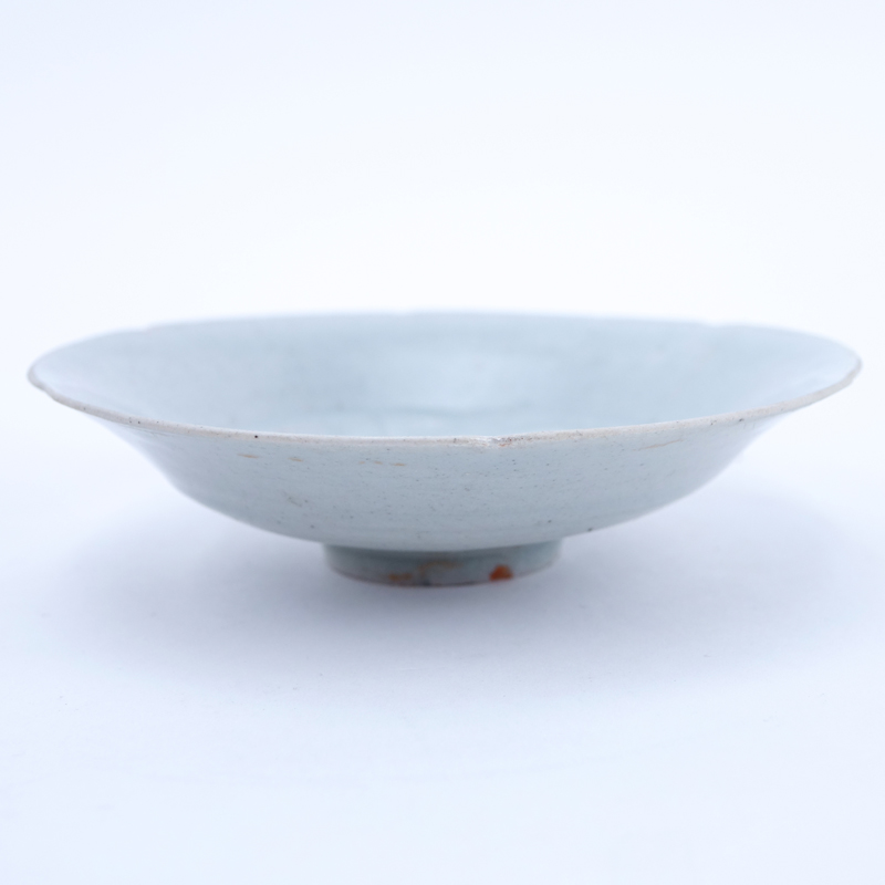 Chinese Song Dynasty (1127–1279) Oingbai Ware Dish. A lobed dish with a central combed peony blossom filling the well covered with pale bluish-green glaze.