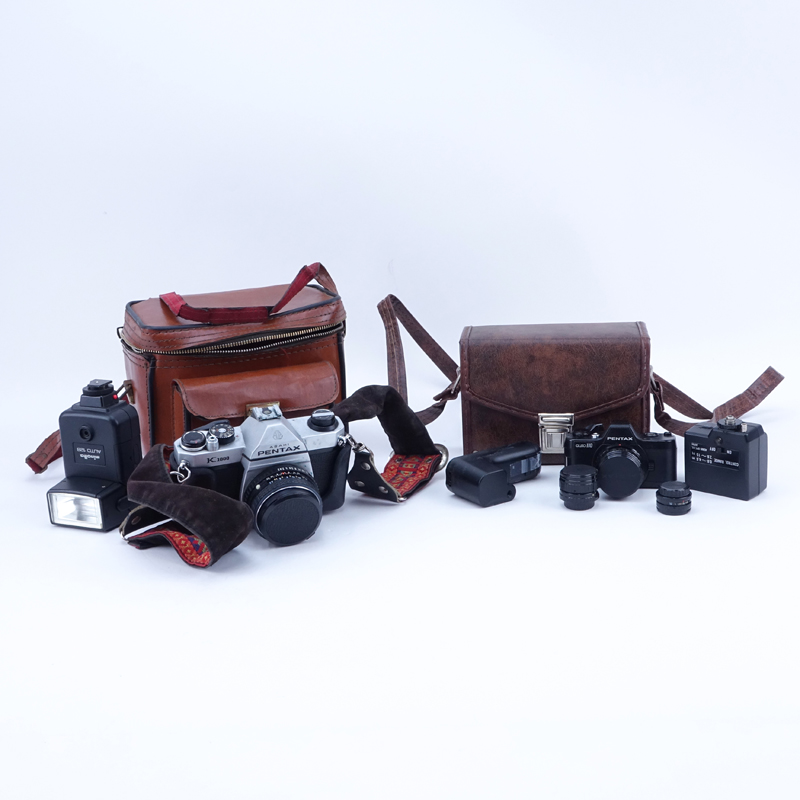 Grouping of Pentax K1000 and Pentax Auto 110 Film Cameras in Leather Traveling Cases. K1000 includes: Minolta auto 128.