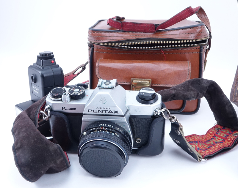 Grouping of Pentax K1000 and Pentax Auto 110 Film Cameras in Leather Traveling Cases. K1000 includes: Minolta auto 128.