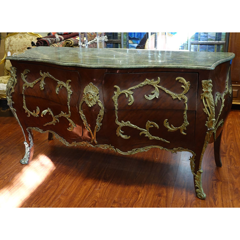 Large Louis XV Style Gilt Bronze Mounted Marble Top Commode. Includes four drawers with foliage form mounting and figural bust en centre.