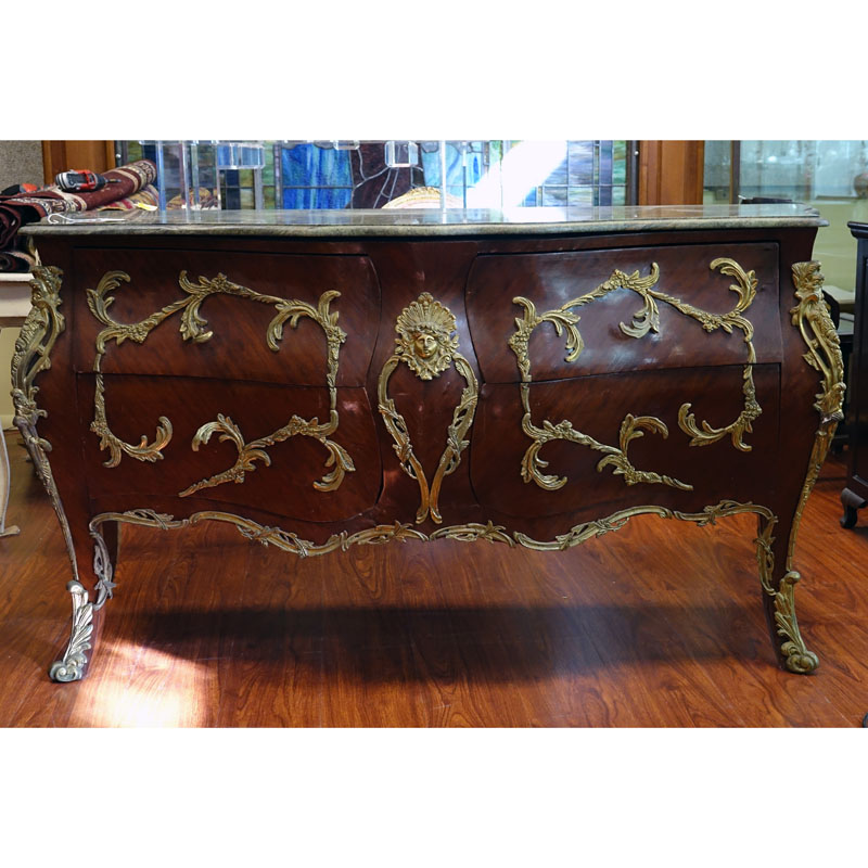 Large Louis XV Style Gilt Bronze Mounted Marble Top Commode. Includes four drawers with foliage form mounting and figural bust en centre.