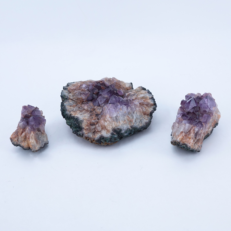 Three (3) Amethyst Geodes. Largest measures 4" H x 9" W.