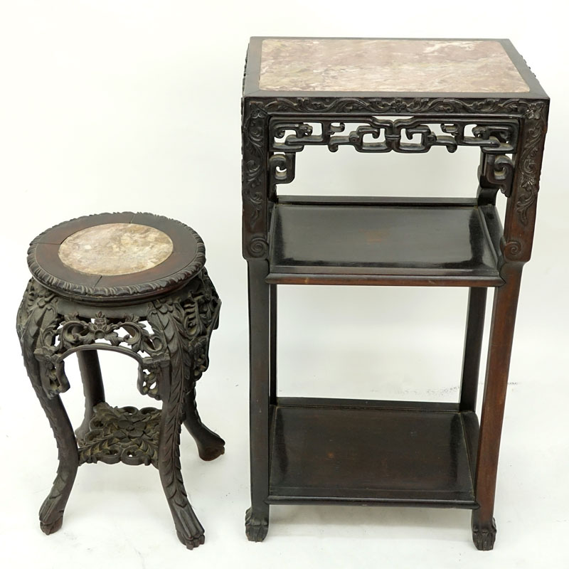 Two (2) Chinese Carved Rosewood and Marble Top Stands. Large stand has old wood worm damage to a portion of one leg but does not appear to be active, both stands have scratches, splits, and nicks.