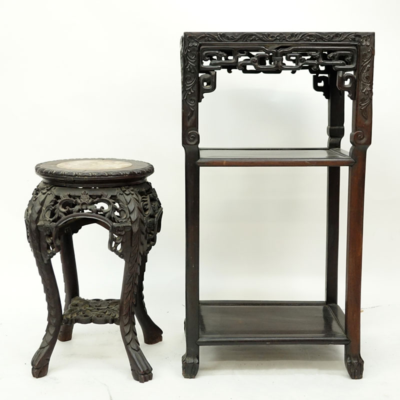 Two (2) Chinese Carved Rosewood and Marble Top Stands. Large stand has old wood worm damage to a portion of one leg but does not appear to be active, both stands have scratches, splits, and nicks.