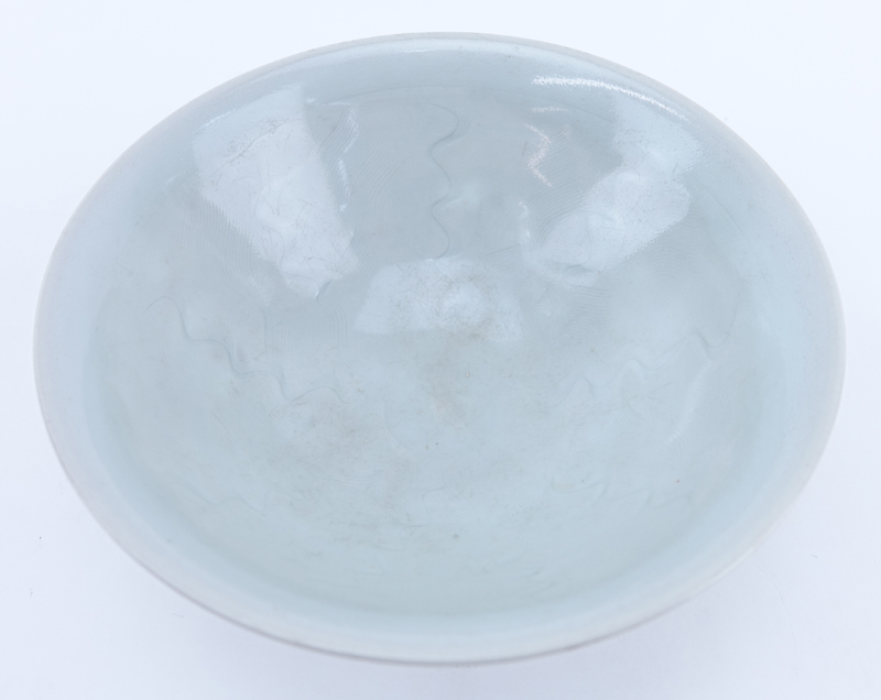 Chinese Song Dynasty (1127–1279) Oingbai Ware Bowl. a bowl with freely combed wavy lines in the interior covered with pale bluish-green glaze.