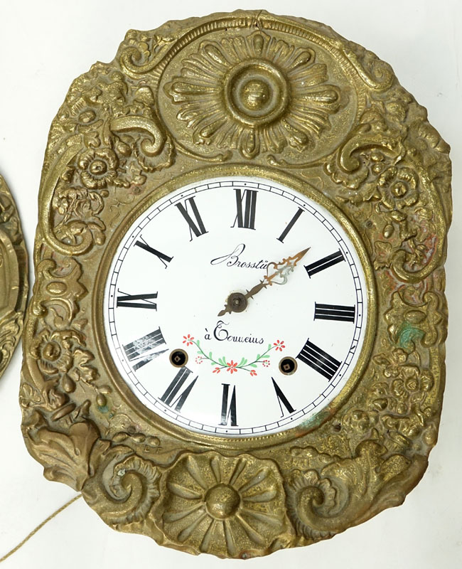 Antique French Brass High Relief Morbier Clock. Inscribed on dial with Roman numerals and decorative hands.