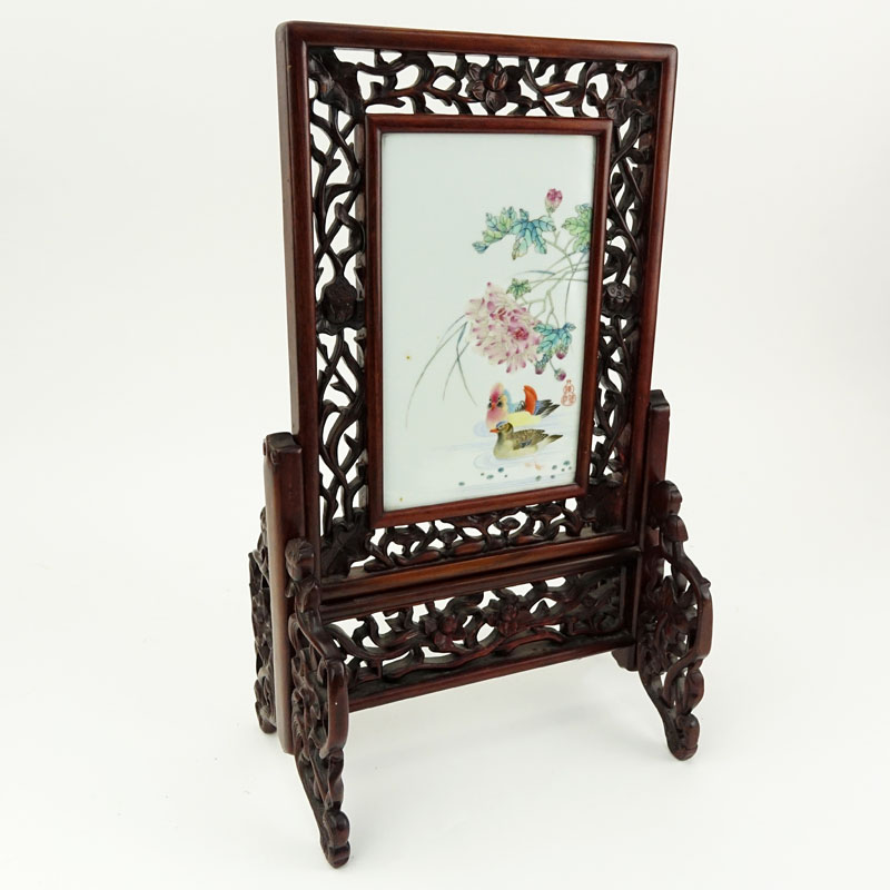 19/20th Century Chinese Hand Painted Porcelain Plaque Mounted in Carved Hardwood Frame As Table Screen. Decorated with colorful bird and flower motif.