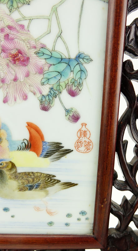 19/20th Century Chinese Hand Painted Porcelain Plaque Mounted in Carved Hardwood Frame As Table Screen. Decorated with colorful bird and flower motif.
