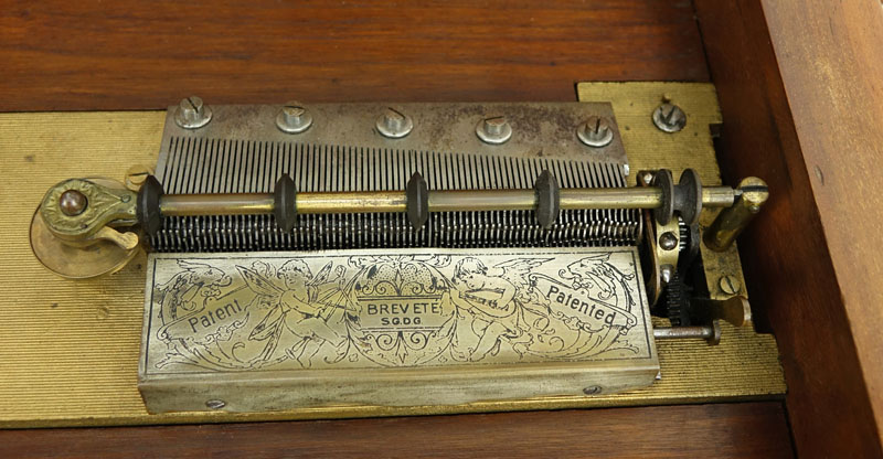 Antique Polyphon Brevete SGDG Music Box with 38 Discs atop a Associated Base. Walnut case with floral inlay top.