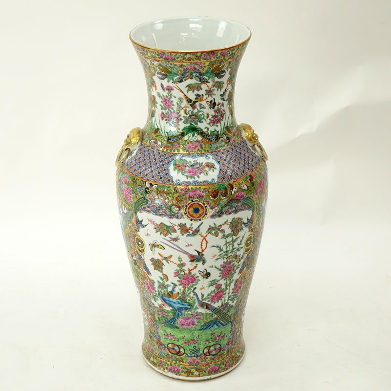 Large Chinese Rose Canton Porcelain Vase with Mock Foo Dog Ring Handles. Enamel and gilt painted panels of birds, butterflies, coins, and exotic flowers.