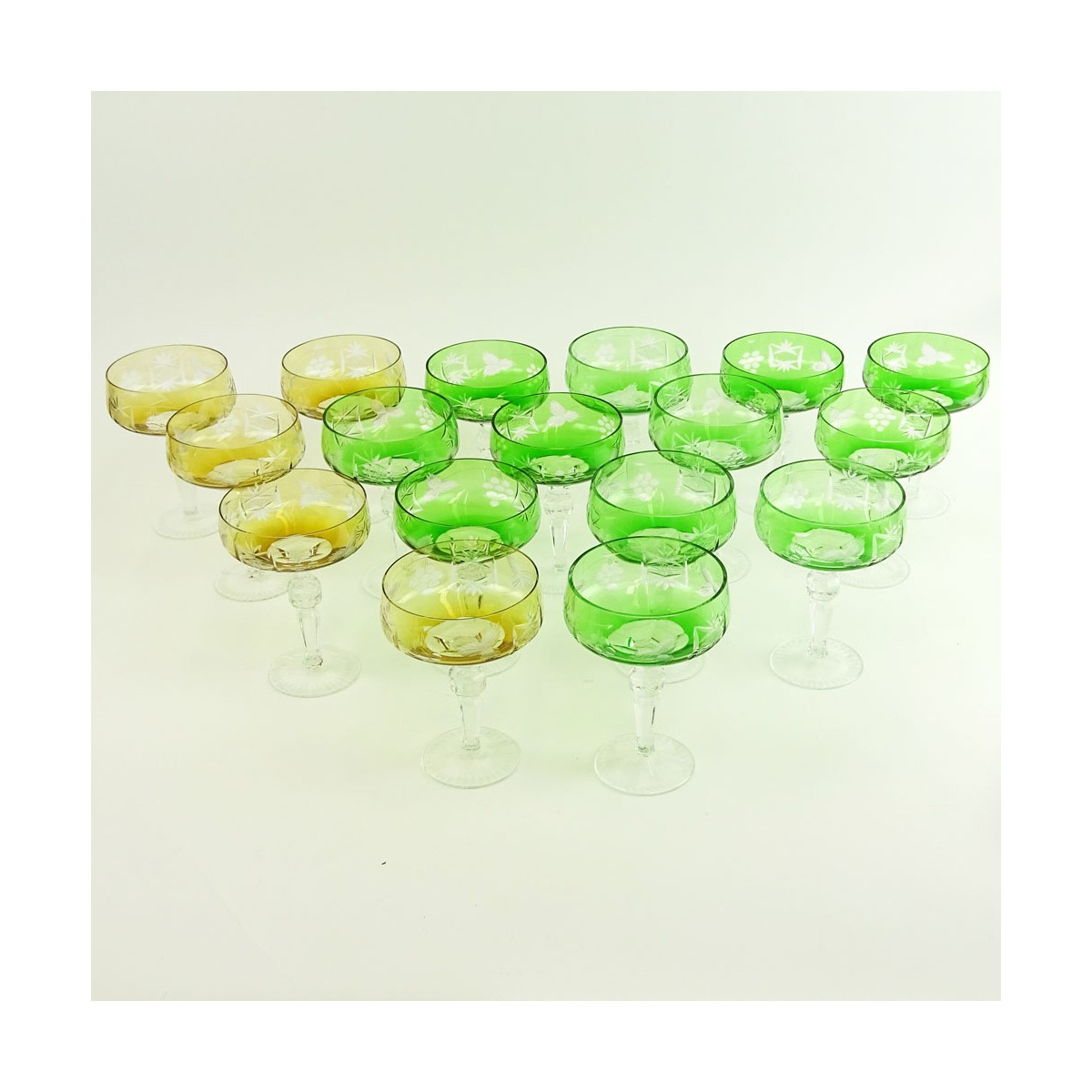 Lot of 17 Bohemian Cut Glass Champagne Coupes in Green (12) and Amber (5). Measure 5-5/8". Very goo