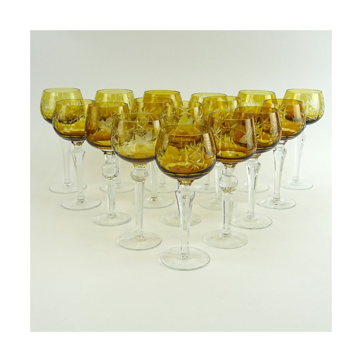 Lot of 16 Bohemian Cut Glass Wine Hocks in Amber. Various stems. Measures 8" to 8-1/4". Very good c