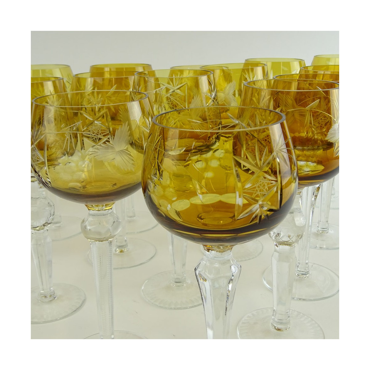 Lot of 16 Bohemian Cut Glass Wine Hocks in Amber. Various stems. Measures 8" to 8-1/4". Very good c