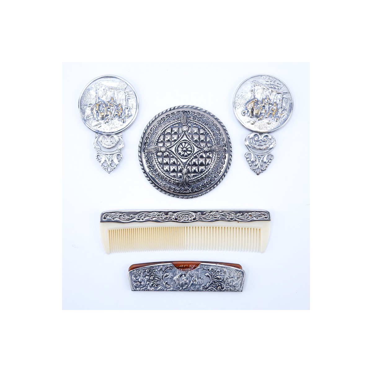 Collection of Five (5) Repousse Silver Plated Vanity Items. Includes: two combs and three mirrors.