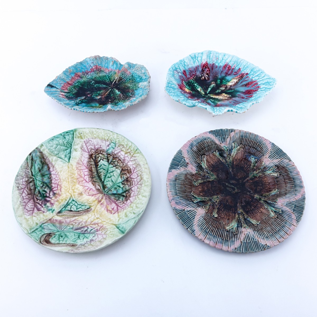 Four (4) Vintage Majolica Pottery Plates. Various leaf motifs. One signed Etruscan Majolica. Small
