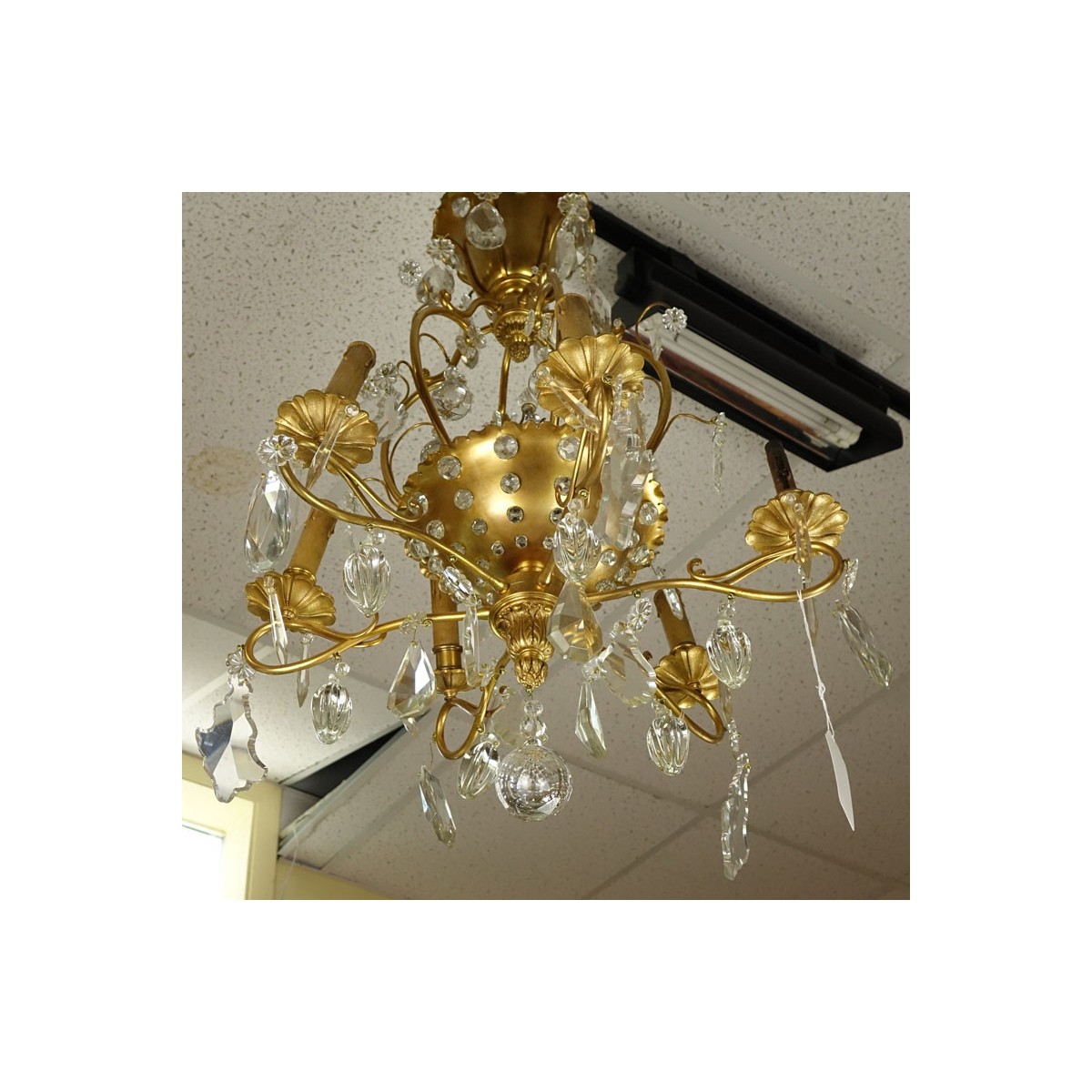 Late 19th/Early 20th Century Rococo Style Gilt Bronze and Crystal 6-Arm Chandelier. Decorated with