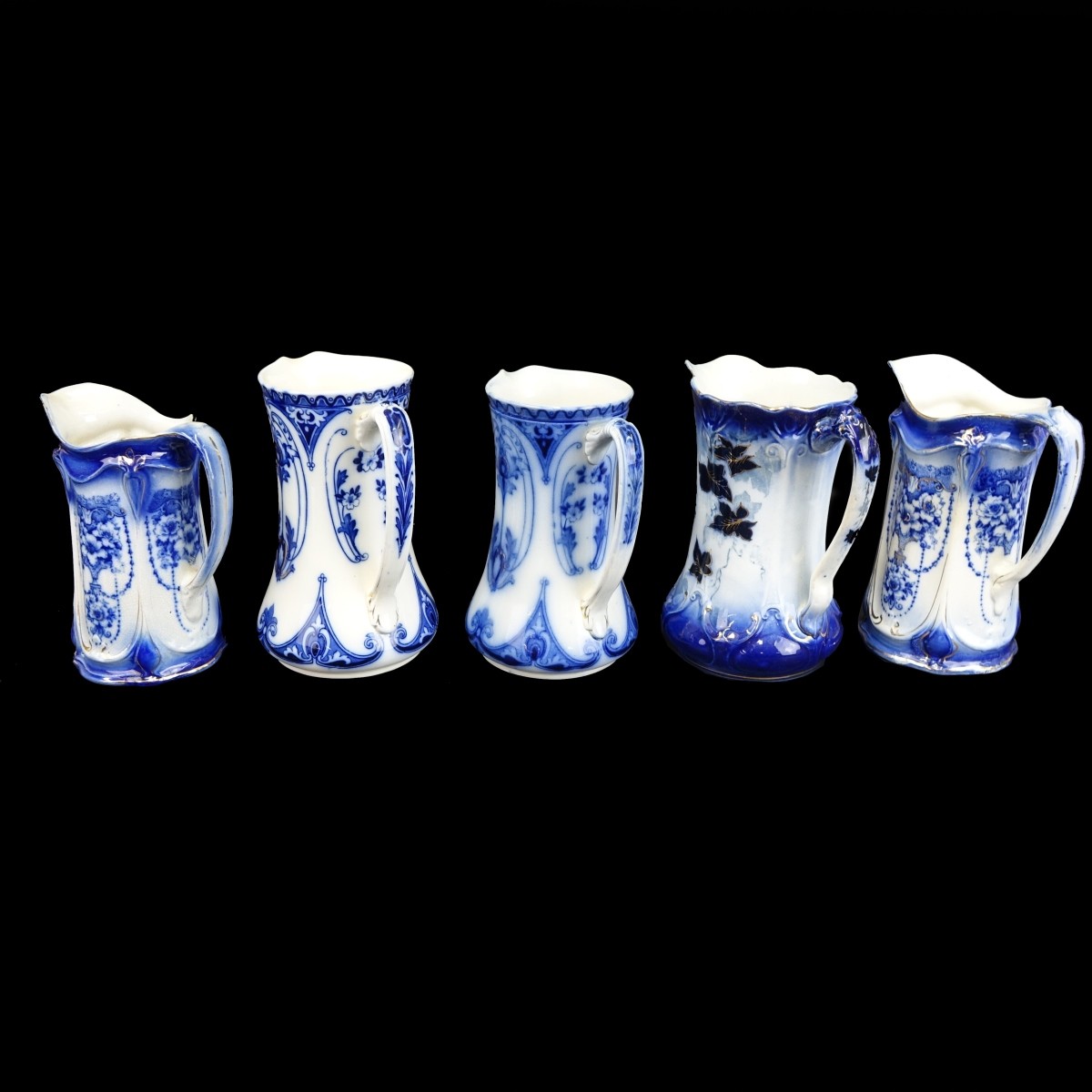 Five (5) Antique Flow Blue Porcelain Pitchers